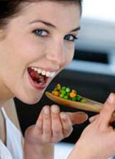 Image : jeune femme mange des légumes