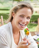 Image : Jeune femme mange une salade
